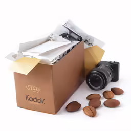 a camera, a box and nuts all in the same photo
