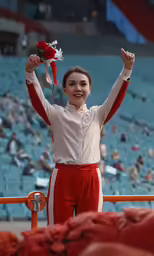 a young woman holding her arms in the air