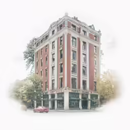 an old brick building with cars parked outside