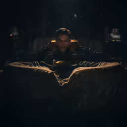a man is laying on a bed and staring at something