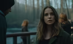 a woman in black standing next to some people
