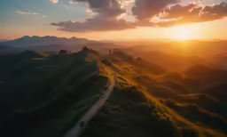aerial view of the sun rising over a hill side