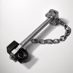a black and white photo of a camera strapped to a long metal chain