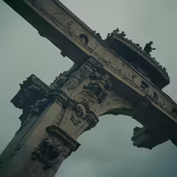 a stone archway against a cloudy blue sky