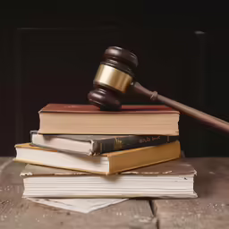 the judge gaven sits atop the books, on top of them