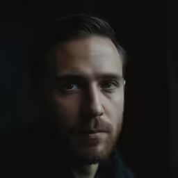 man with a beard and blue eyes looking into the camera
