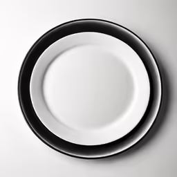 white plate with black edge on a gray table