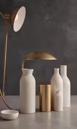 three vases, one has a lamp and the other is a vase