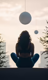 woman looking at two ball balls on a rooftop