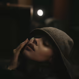 a woman is laying on her head and looking up with eyes closed