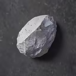 a rock shaped sculpture sits on the floor