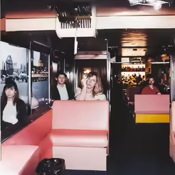 there are people inside the diners or bars eating