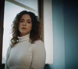 a beautiful woman in white is looking away from the camera