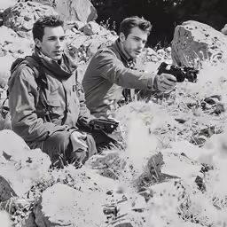 two men on the rocks with their cameras