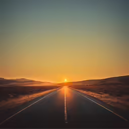 the sun is setting in a wide open space