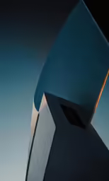 there is a tall building with a circular window at the top