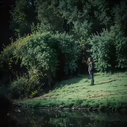a man is walking on a small hill by a lake