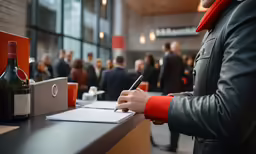 a man at a counter writing on a paper
