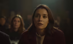 the woman looks surprised at something in the background