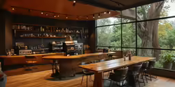 an empty restaurant area with a bar and large windows