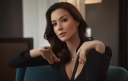 a woman in a black dress posing for the camera