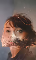 an image of a woman looking through her fingers at the sky
