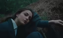 a woman with her head by her hands on the ground