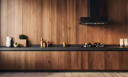 an empty kitchen has a black stove, and candles on the counter