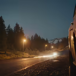 cars are driving on a road at night