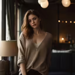 a woman in a beige sweater is looking down