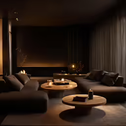 a living room filled with furniture and lit candles