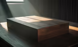 an empty square wooden box on top of a wooden table