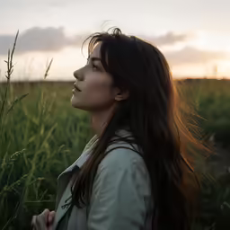 a beautiful woman with long hair is in the middle of a field