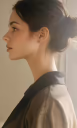 an asian woman is looking off in the distance