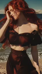 a beautiful young woman in a brown dress posing on the beach