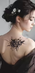 a woman has a tattoo on her shoulder