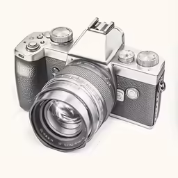 a silver camera with a lens attached to it