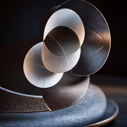 three black and white sculptures on a blue table