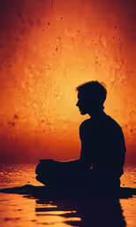 a silhouette of a person sitting on the water at sunset,man sitting in the water while staring at a sunset