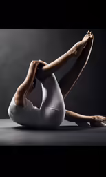 a woman in white sitting on her back with her legs spread open