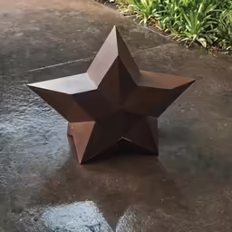 this is a brown paper star sitting on the ground