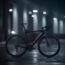 a dark bicycle sits in a dimly lit area