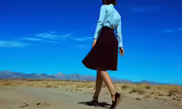 the woman walks down the road carrying luggage