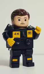 a lego figurine is holding an item that says 4k