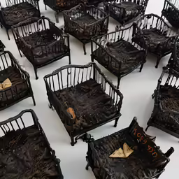 a table topped with lots of chairs covered in mud