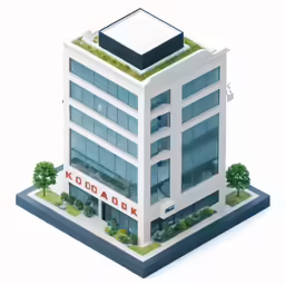 a white building with a green roof and trees