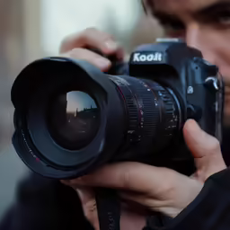 a man holding up a camera to take a photo