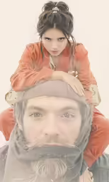 a man sitting on the shoulders of a girl who has a brown jacket