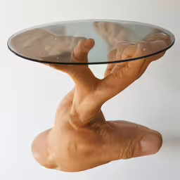 hands holding up a glass table made of clay