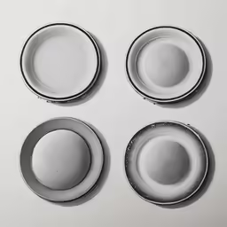 four plates sitting next to each other on top of a table